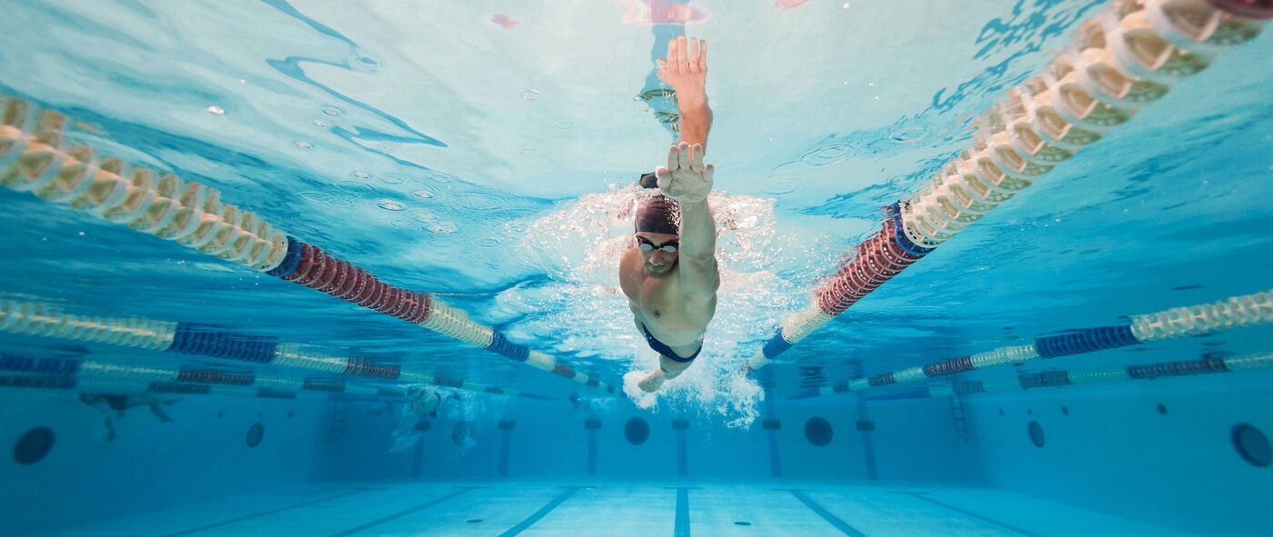 man enjoying a freestyle lap in the pool