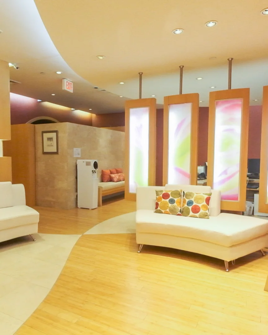 The CGI spa lounge, with glowing partition panels and a curved white sofa