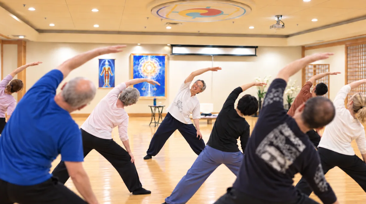 Body & Brain trial class at CGI Holistic: instructor leading a group side stretch