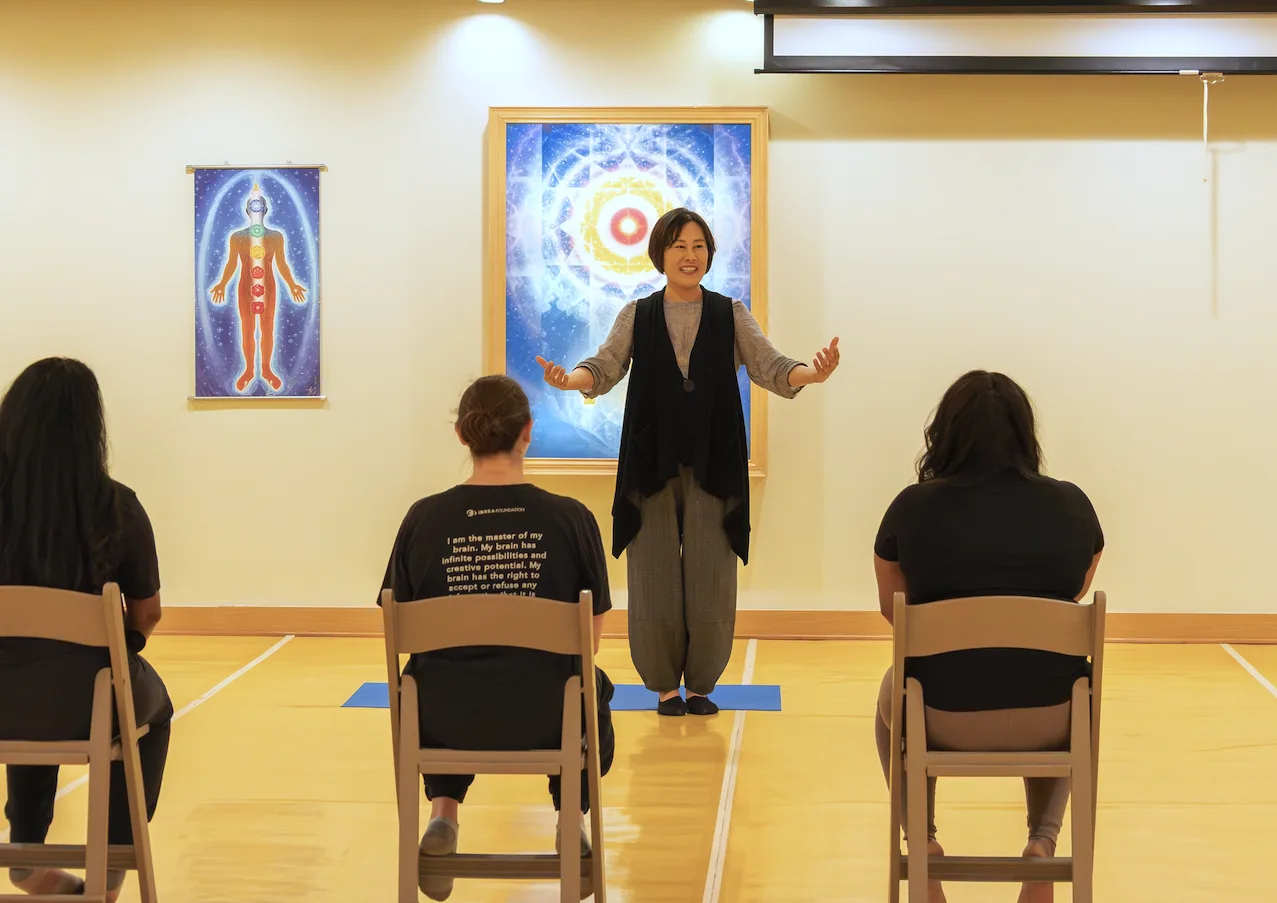 Wellness program class at CGI: instructor guiding a seated group